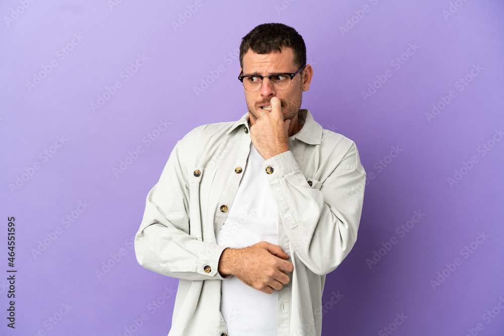Brazilian man over isolated purple background nervous and scared Brazilian man over isolated purple background nervous and scared