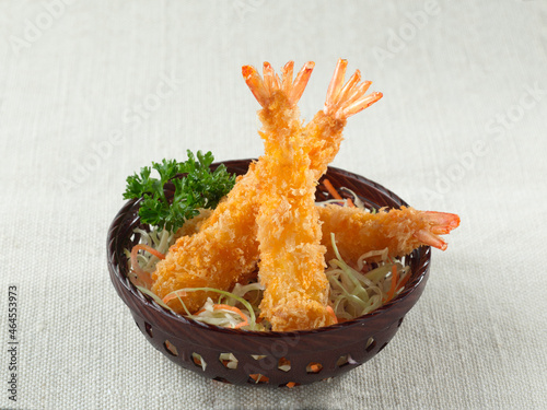 Crispy Breaded Prawns, Panko breaded deep-fried shrimp or Ebi Furai Japanese food in basket on white canvas background.