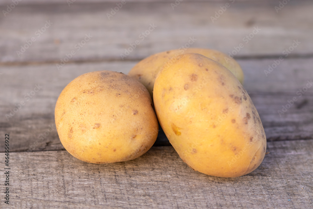 potatoes on a wooden background, concept agriculture. potatoes on a wooden background, concept agriculture.