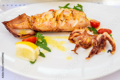 Grilled squid with lemon and cherry tomatoes in Thassos, Greece