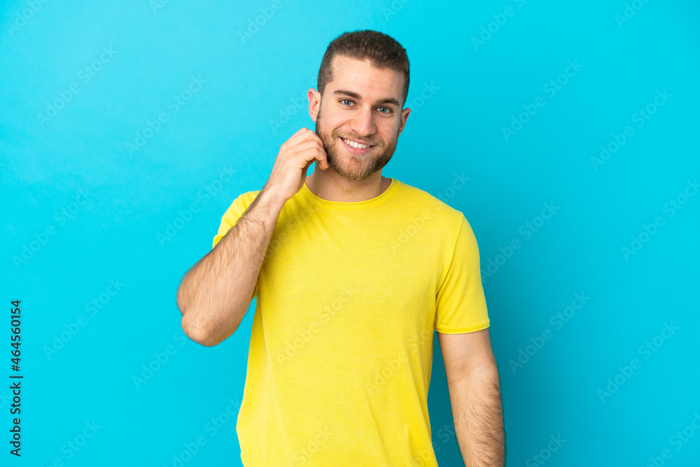 Young handsome caucasian man isolated on blue background laughing Young handsome caucasian man isolated on blue background laughing