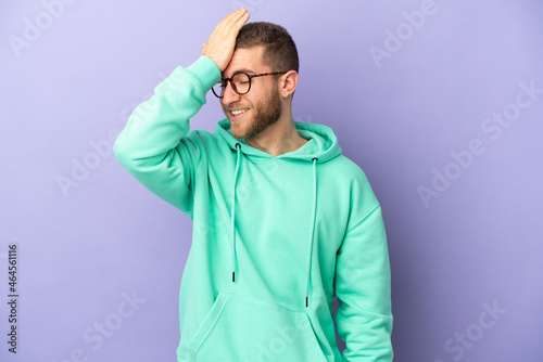Young handsome caucasian man isolated on purple background has realized something and intending the solution © luismolinero