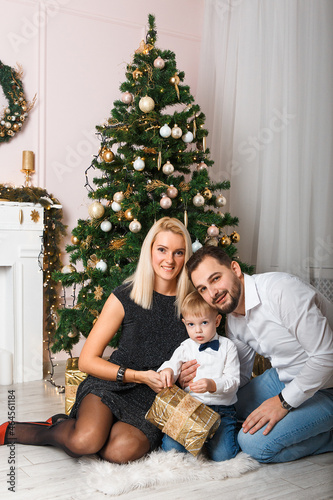Happy young family celebrating christmas at home. © BY-_-BY