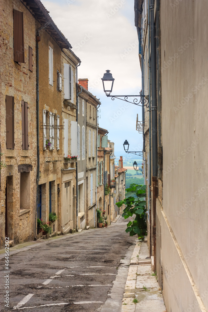 Fototapeta premium Summer city landscape - view of a medieval street in a provincial French town, in the historical province Gascony, the region of Occitanie of southwestern France