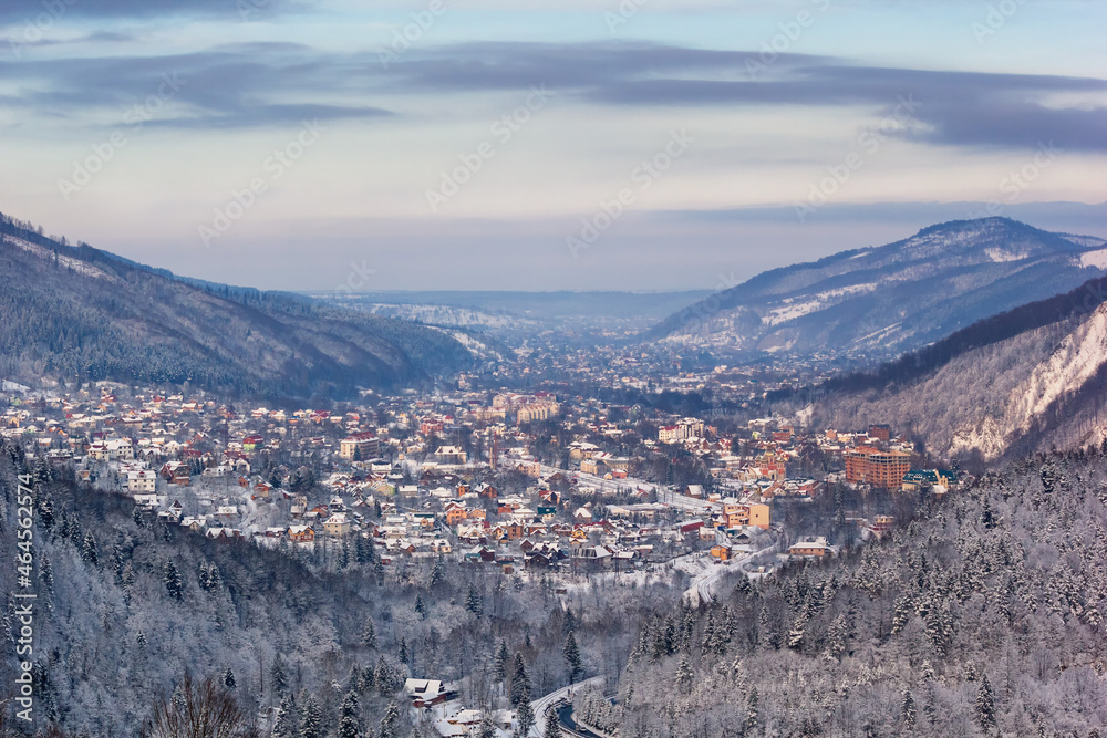 Winter landscape - top view of the snowy mountain valley with the town of Yaremche in the Carpathians, in Ukraine