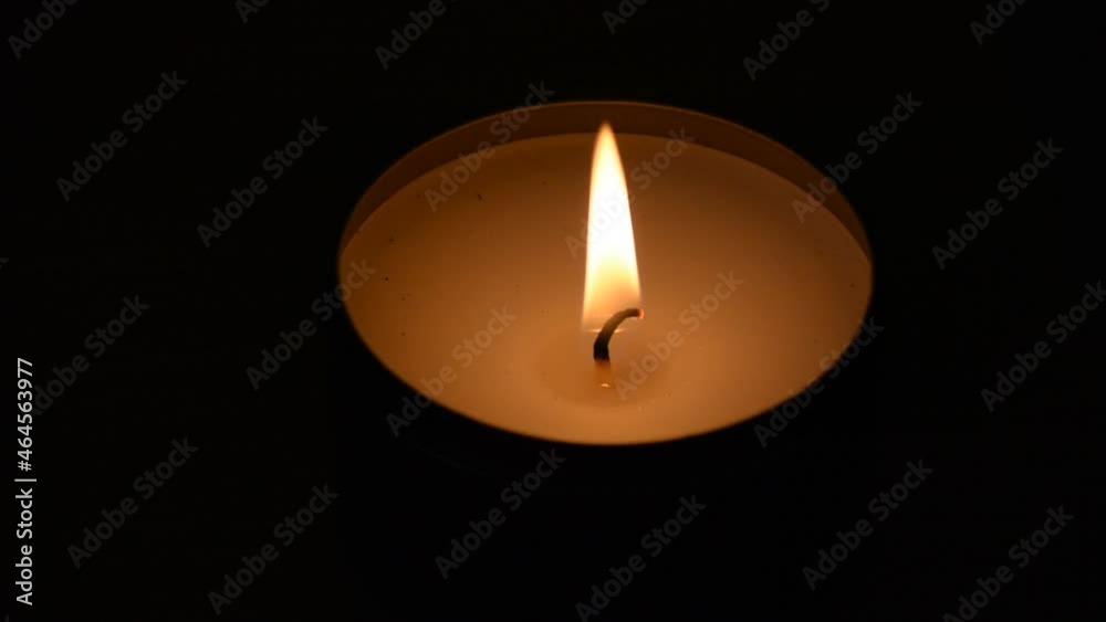 Lonely candle in the dark. Mourning or Religion Background. Candle light on black background. Lonely candle in the dark. Mourning or Religion Background. Candle light on black background.