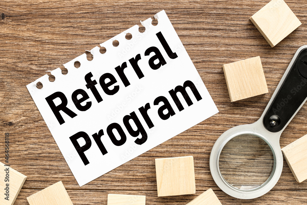 Referral Program. text on white paper on wood background business concept Referral Program. text on white paper on wood background business concept