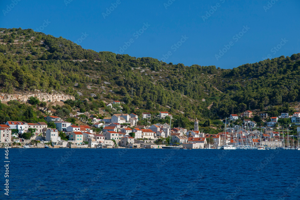 View of the small town on the seashore with boats mooring and people