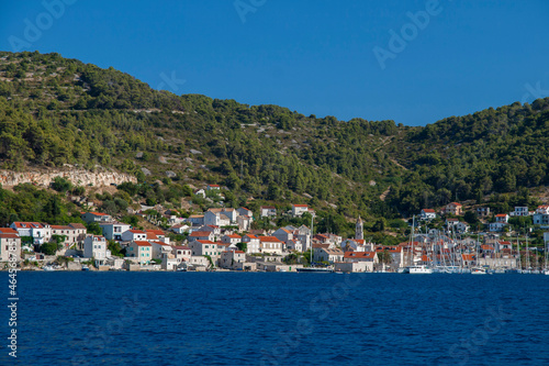 View of the small town on the seashore with boats mooring and people © Tetyana