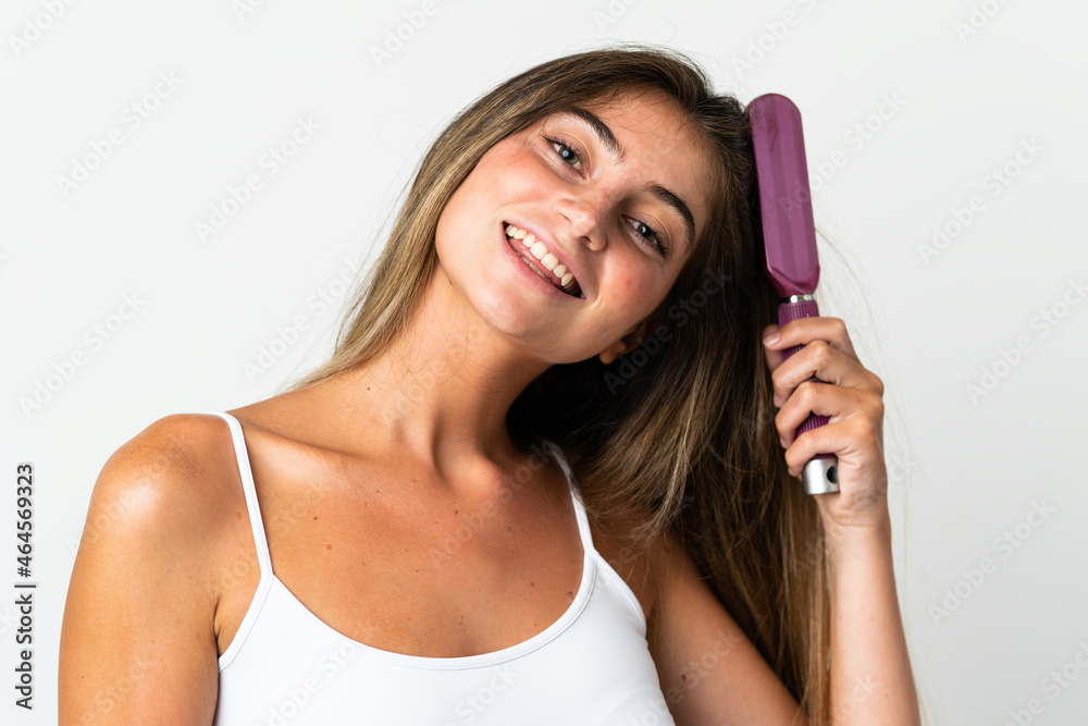 Young caucasian woman isolated on white background with hair comb Young caucasian woman isolated on white background with hair comb