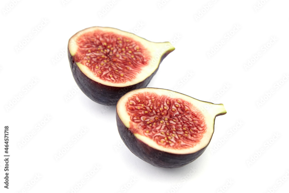 Halves of ripe fig fruit isolated on white