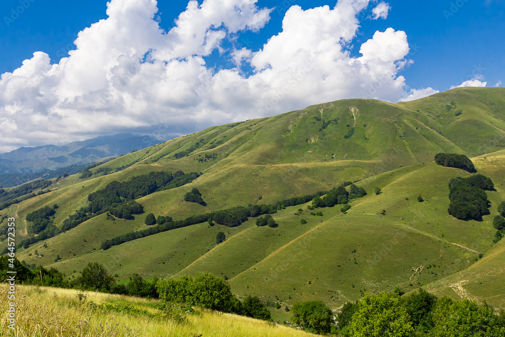 Obraz premium Green mountains of Ossetia. Cascades of mountain peaks against the blue sky. Caucasus