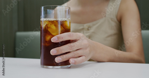 Woman enjoy her iced coffee in cafe