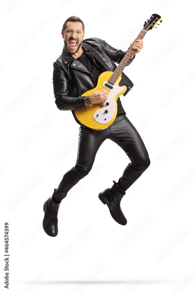 Man in leather clothes playing an electric guitar and jumping Man in leather clothes playing an electric guitar and jumping