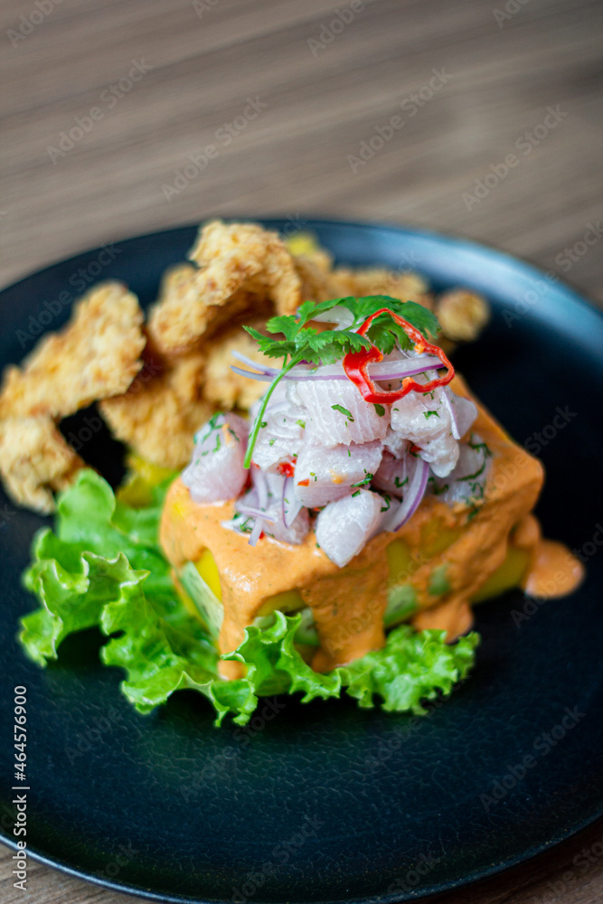 Causa acevichada, accompanied by fried fish.
Causa acevichada, accompanied by fried fish.