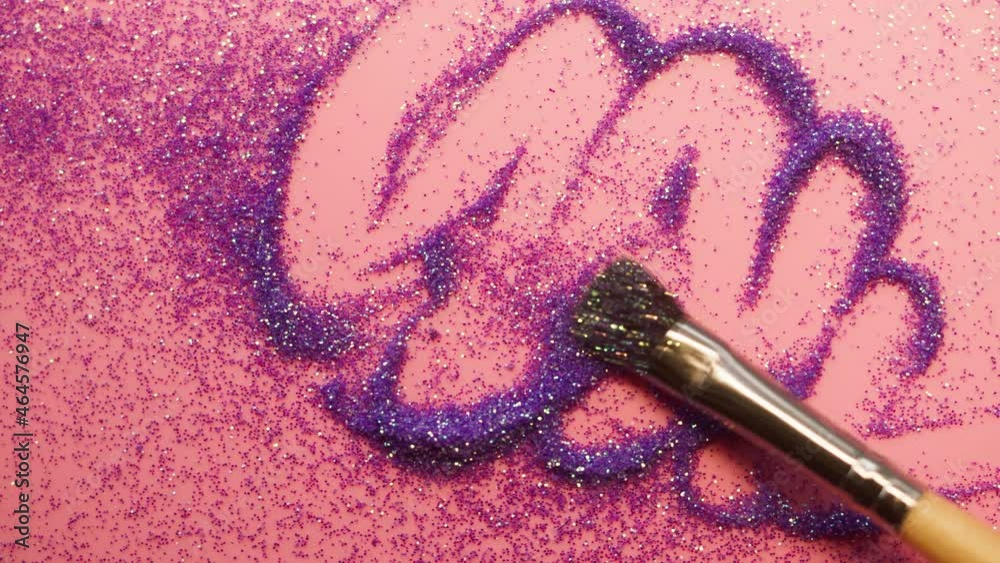 Pretty Smattering Smearing glitter on a pink background, gloss powder close-up. Shining ...