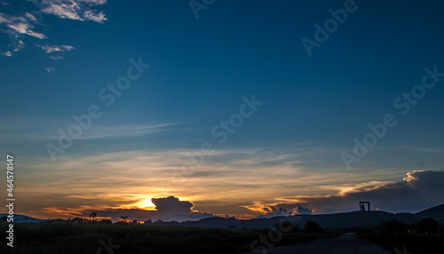 sunset with twilight and silhouette of monument on the horizon photo