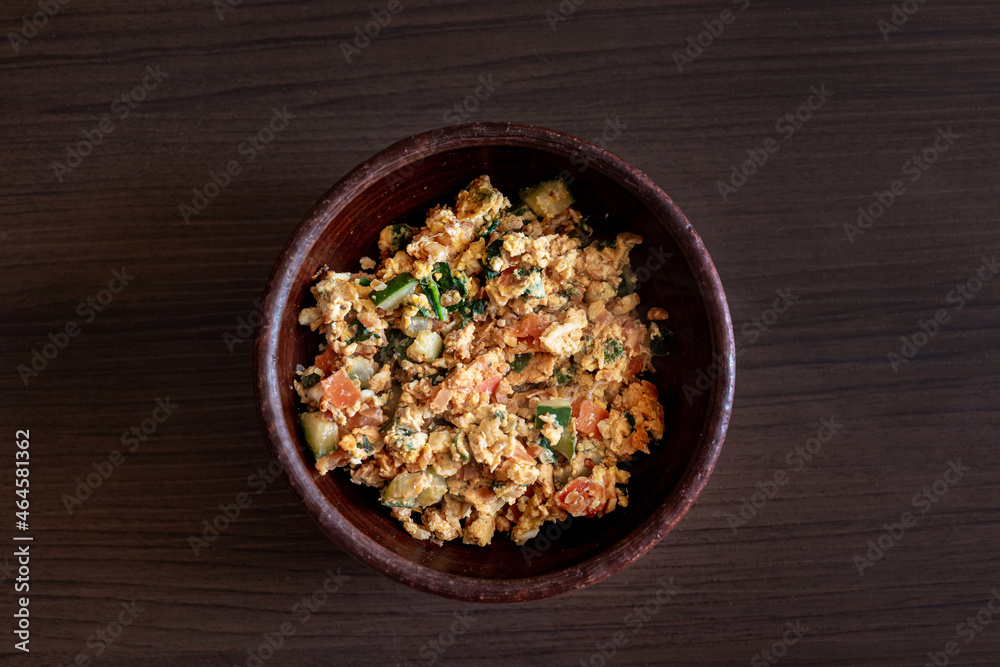 Scrambled eggs on a wooden background