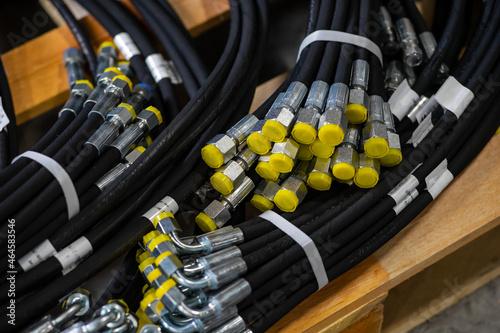 Bundle of new high pressure hydraulic hoses in a package. Hydraulic hoses with yellow plugs