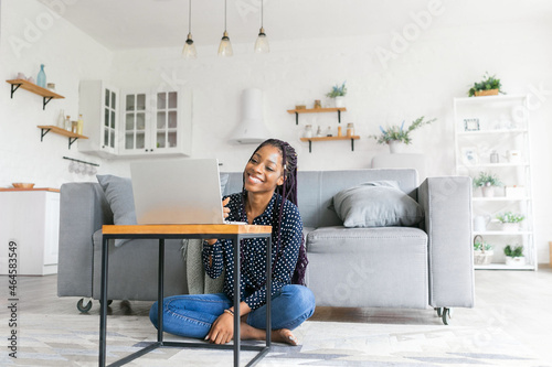 Beautiful young black woman has a zoom call or works in from laptop online webcam talk