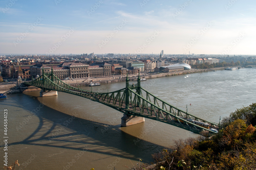 Afternoon view of the sunny city of Budapest (Hungary) with the river Danube, crossed by the green Freedom Bridge