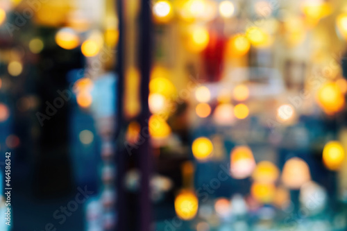 Defocused blurred view of store showcase selling multiple types of house luminaires lamps