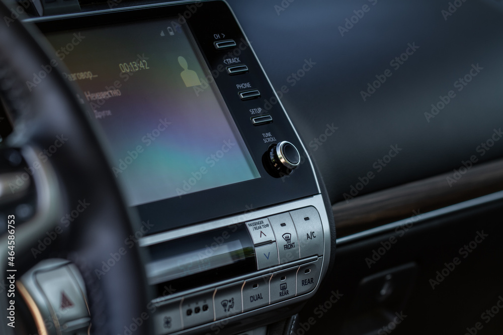 Modern car media display in the interior of the car. Touchscreen monitor on the dashboard of the modern car. Modern car media display in the interior of the car. Touchscreen monitor on the dashboard of the modern car.