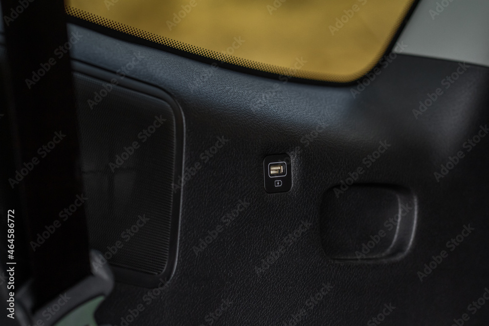 Opened car USB port in the car for connecting device. Power output of usb charger close up view. Car interior.