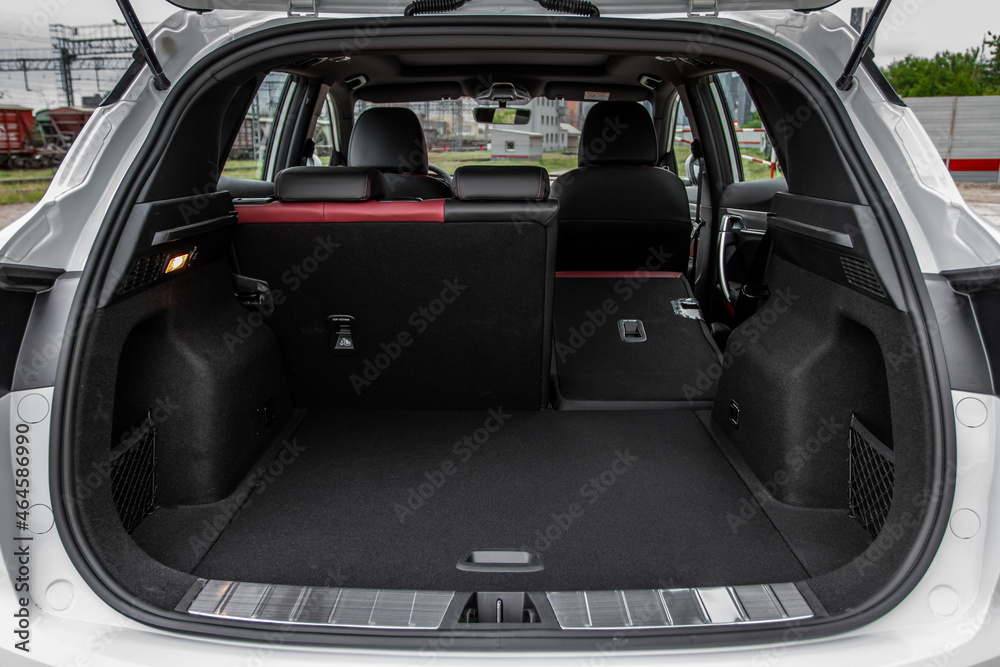 Huge, clean and empty car trunk in interior of compact suv. Rear view of a SUV car with open trunk - obrazy, fototapety, plakaty 