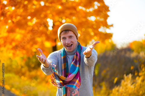 Young handsome man wearing winter sweater. Autumn background. Happy day. Celebration © Erika