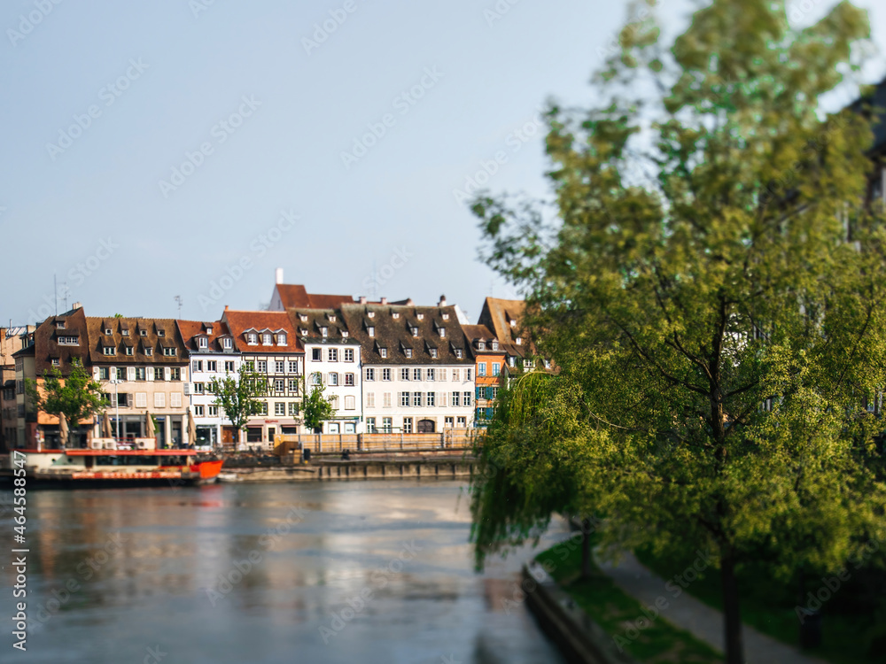 Tilt-shift view of Main street in Strasbourg with timbered houses and Ill river