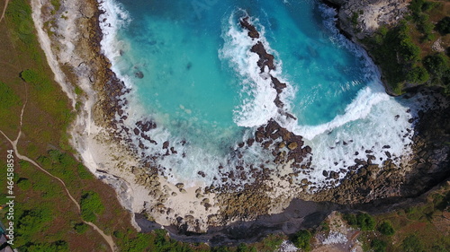 Blue lagoon ocean sunny day crystal clear water paradise to visit summer Bali Indonesia travel vacation tourist destination drone view shades of blue nature stones rocks