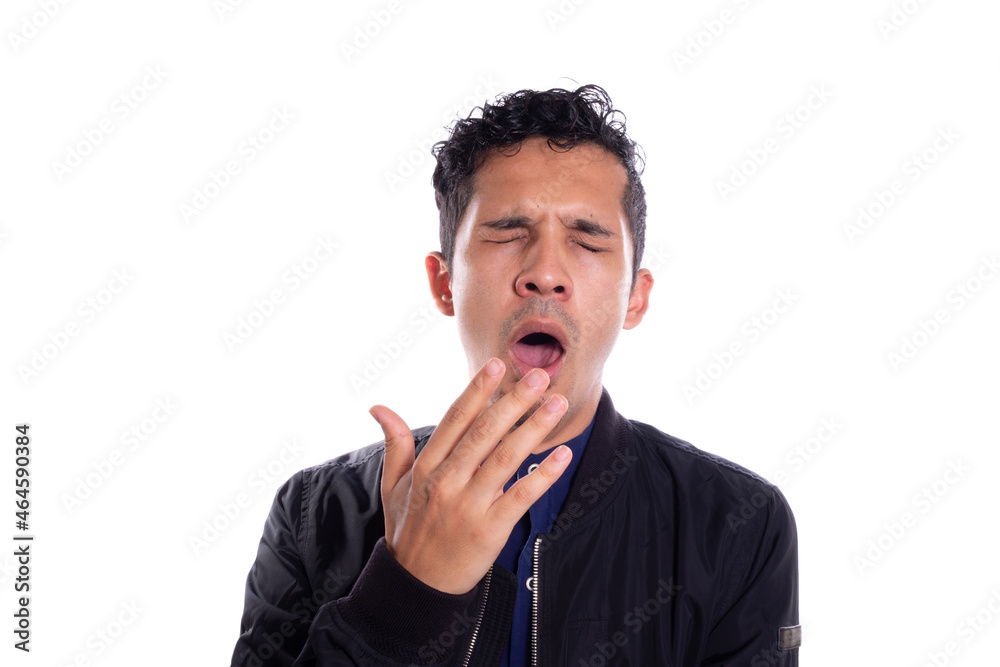 Young adult young man yawning, isolated on white background. Latin man yawning with hand near his mouth. Young adult young man yawning, isolated on white background. Latin man yawning with hand near his mouth.