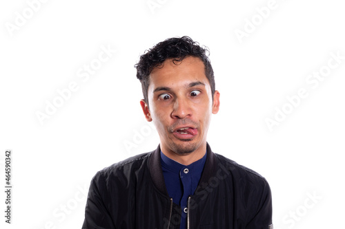 Crazy man sticking out his tongue, isolated on white background. Young adult young visco with crazy expression.