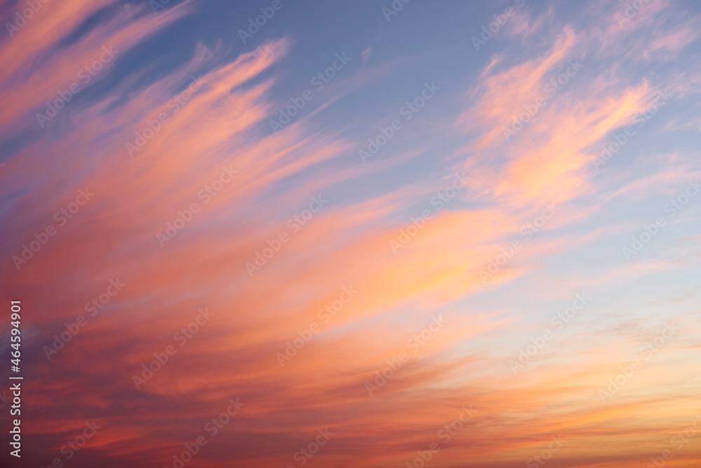 Beautiful sunset sky background with fiery clouds. Colorful sunset sky with yellow, orange, and pink color