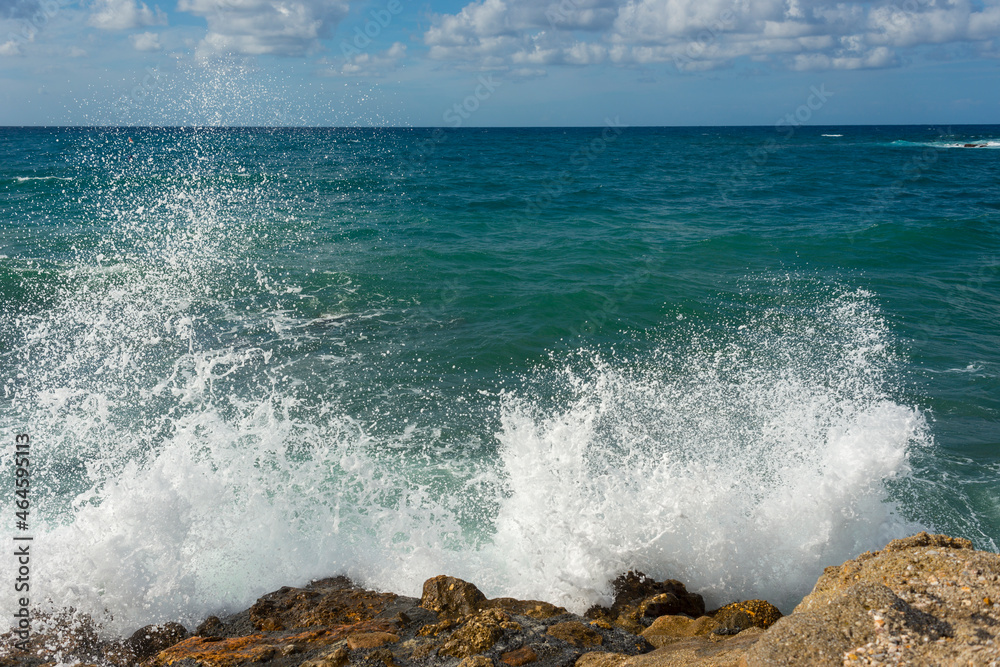landscape of stormy Mediterranean sea with blue sky and white clouds and white sea foam off the coast of Turkey, Avsalar, Alanya during a storm in autumn landscape of stormy Mediterranean sea with blue sky and white clouds and white sea foam off the coast of Turkey, Avsalar, Alanya during a storm in autumn