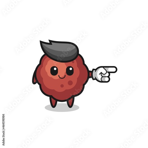 meatball mascot with pointing right gesture