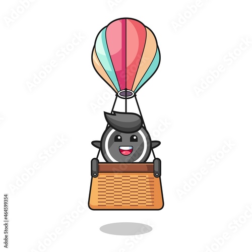 hockey puck mascot riding a hot air balloon