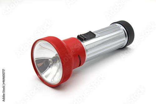 Vintage metal red flashlight torch, made in Yugoslavia, isolated on a white background