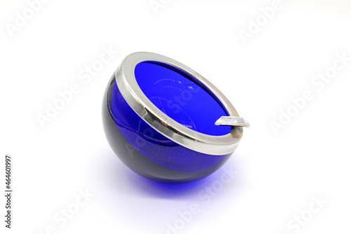 Blue vintage glass and metal ashtray, isolated on a white background