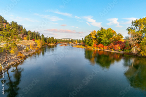 Large boulders along Spokane River as fall leaves turn colors at Autumn at Islands Trailhead along the Centennial Trail in Spokane, Washington, USA