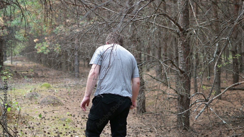a lonely man with glasses walks through a dark autumn forest a lonely man with glasses walks through a dark autumn forest