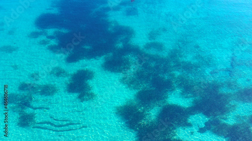 Aerial view of the ocean surface with clear water