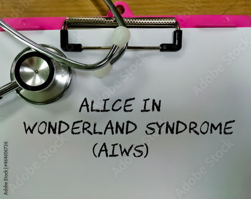 Alice in Wonderland syndrome (AIWS) word isolated on clipboard with stethoscope photo