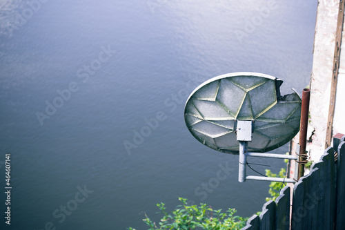 Satellite dish over river 