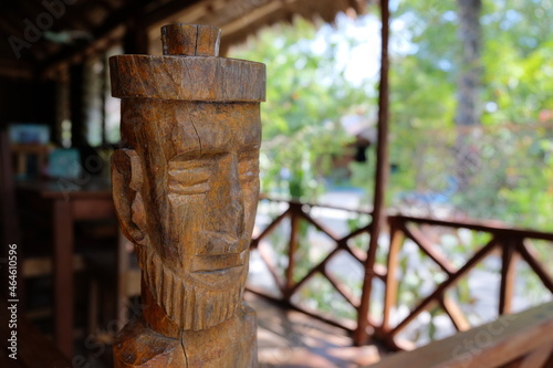 A traditional wooden carved statue of Timorese person on a remote, secluded tropical island in Timor Leste