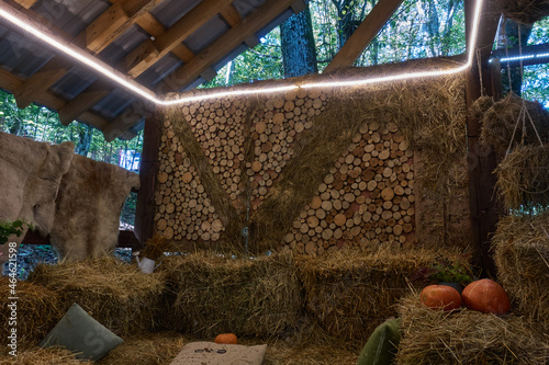 Christmas reindeer parking lot with hay, pillows and pumpkins. A backlight with a diode strip is inserted on top.