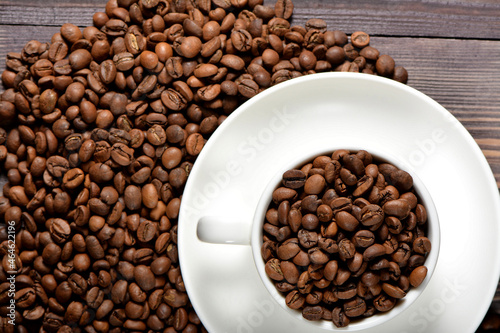 White coffee mug filled with coffee beans