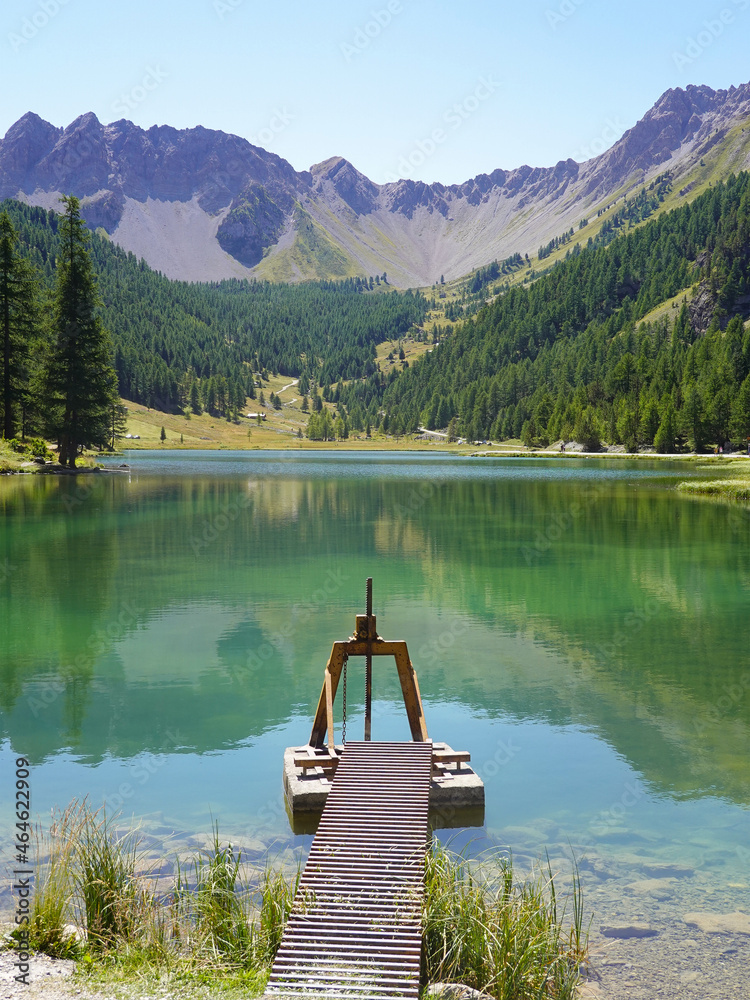 Obraz premium Lake Orceyrette with its pontoon and metal sluice gate. Briancon.