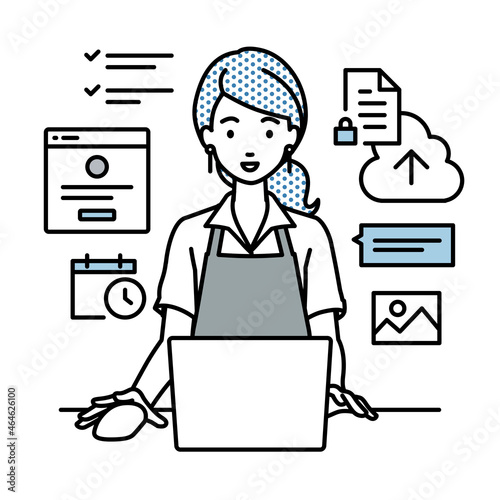 デスクで座ってPCでプロジェクトやタスクの管理の仕事をしているカフェ店員の女性